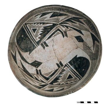 A Mimbres Style III bowl with designs showing intertwined snakes and fish.  From the Ronnie site, in southwestern New Mexico